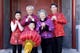 Chinese New Year family performing traditional greeting.